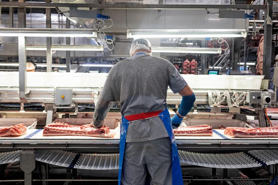 Butcher at the roast pork line